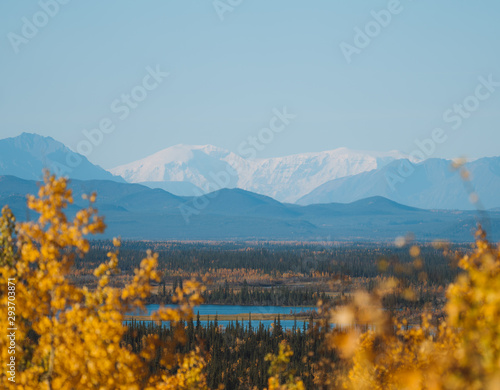 Remote lake in autumn forest with big mountain in background in Alaska