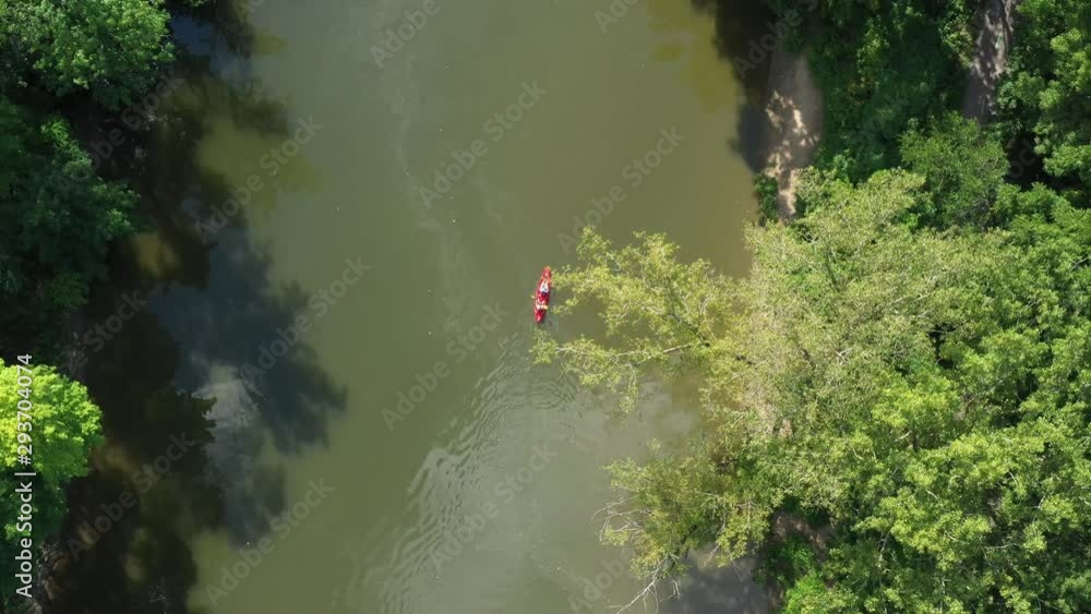 Kayak travelling slowly down a calm river Kayak travelling slowly down a calm river