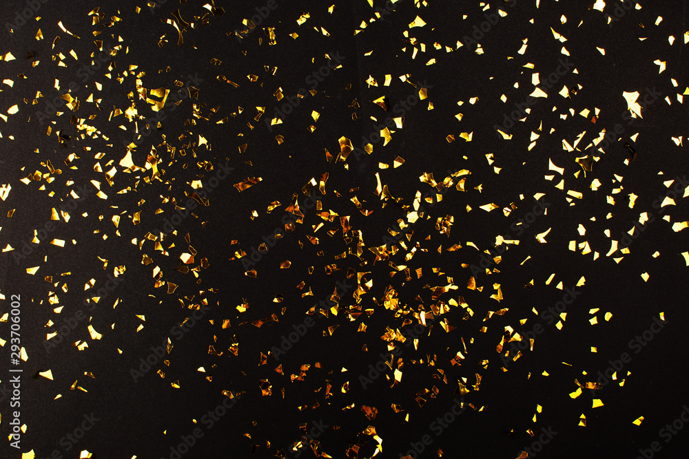 Gold foil confetti on black background. Flatlay. - obrazy, fototapety, plakaty 