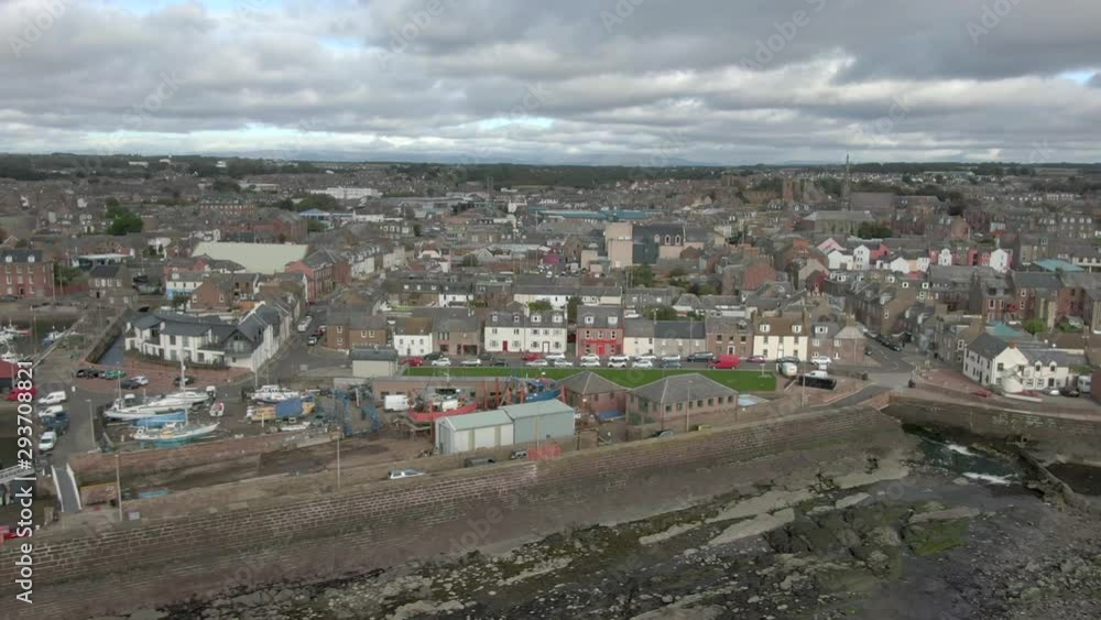 An aerial view of Arbroath harbour and town on a cloudy day. Tracking shot left to right from the harbour across the town with zoom in. An aerial view of Arbroath harbour and town on a cloudy day. Tracking shot left to right from the harbour across the town with zoom in.