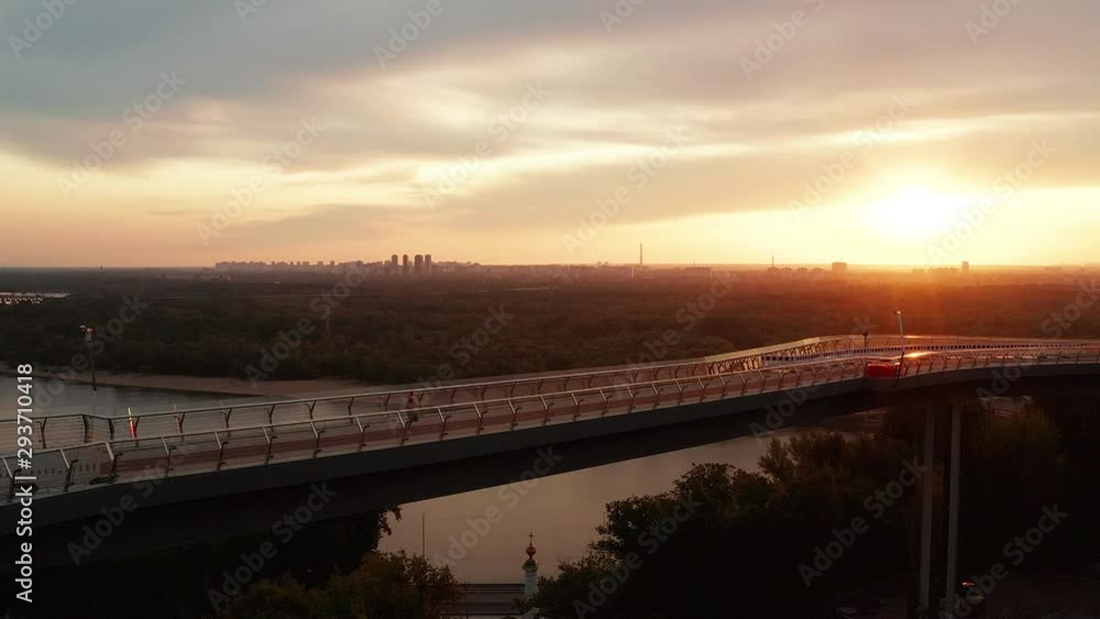 Kiev, Ukraine-August 2019: A girl runs on a cycling footbridge in Kiev. Drone view 4K issue Kiev, Ukraine-August 2019: A girl runs on a cycling footbridge in Kiev. Drone view 4K issue