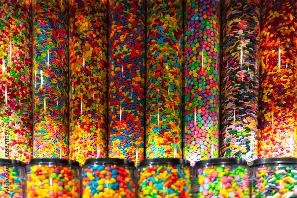 Colorful candies in jars as background