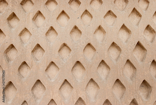 Adobe wall with rhombus designs at Chan Chan city in Perú.  photo