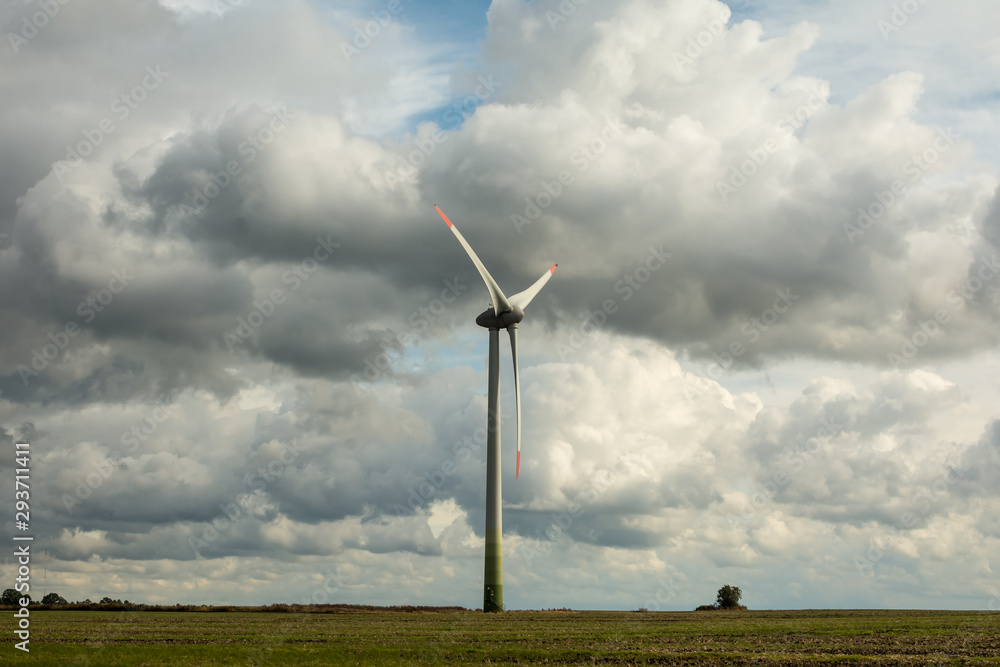 Fototapeta premium Wind turbine farm in the field a renewable energy source