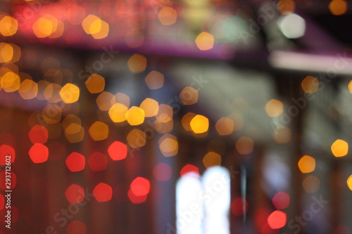 Beautiful blurry image of bokeh light on street during festival such as Christmas, New Year. De focus at colorful light bulbs.