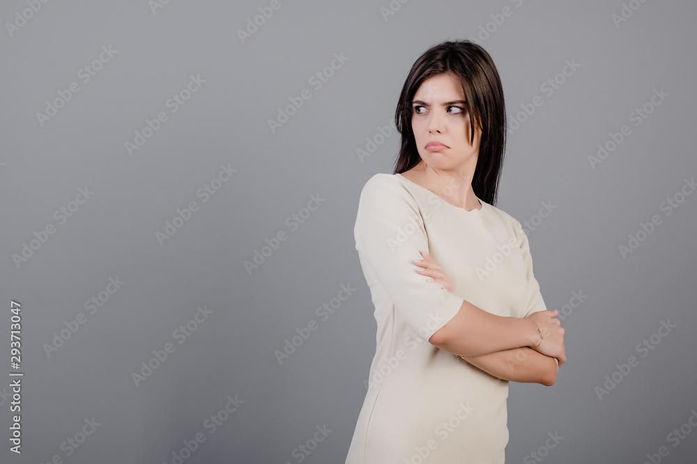 beautiful brunette woman unhappy looking at copyspace isolated over grey beautiful brunette woman unhappy looking at copyspace isolated over grey