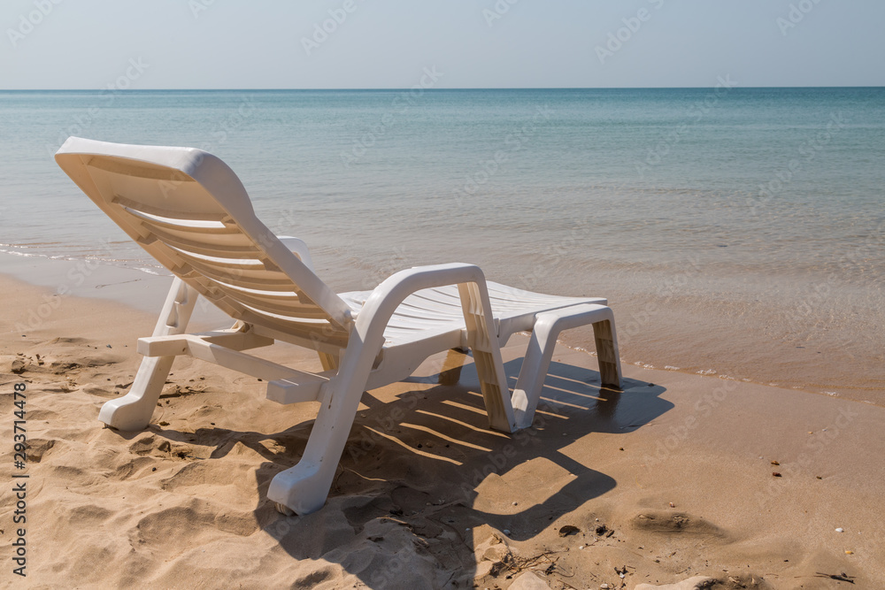 Beach chair at sunny coast at the beach Beach chair at sunny coast at the beach