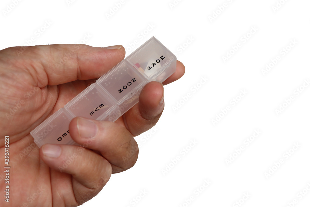 Pill organizer with pills in hand or palm of a patient or elderly isolated on white background. Close-up. Pill organizer with pills in hand or palm of a patient or elderly isolated on white background. Close-up.