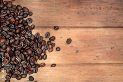 Top view coffee beans with copy space on wooden background.