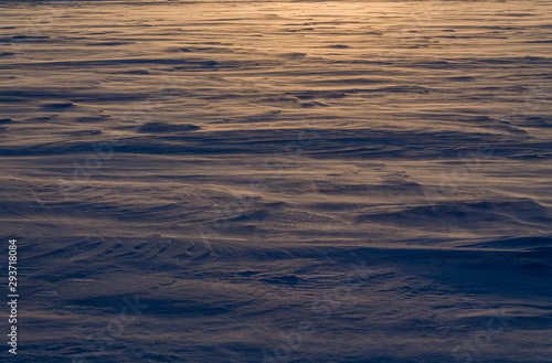 Dawn on the frozen lake. Strong wind and Blizzard. Low freezing temperature.