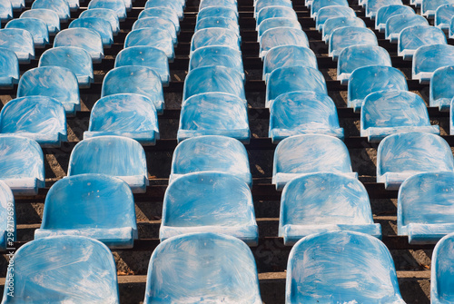 Many old blue chairs in a football stadium, for visitors needing replacement or reconstruction