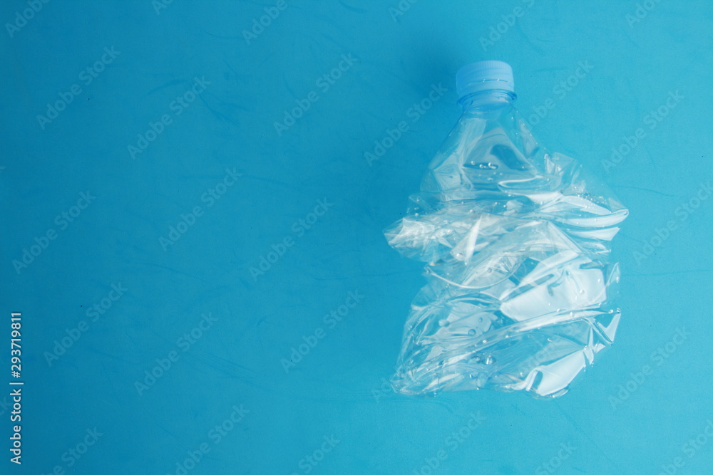 Empty plastic water bottle scaled for recycling