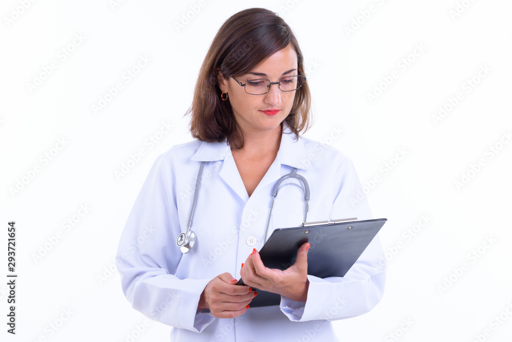 Beautiful woman doctor with eyeglasses reading on clipboard Beautiful woman doctor with eyeglasses reading on clipboard
