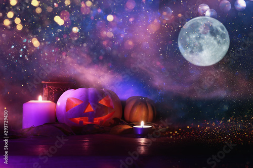 Fototapeta Naklejka Na Ścianę i Meble -  holidays image of halloween. Pumpkins over wooden table at night scary, haunted and misty forest
