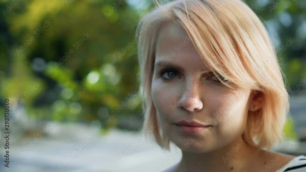 Closeup Beauty portrait of young woman face with blue eyes. Girl with lovely look and natural make up slow motion Closeup Beauty portrait of young woman face with blue eyes. Girl with lovely look and natural make up slow motion