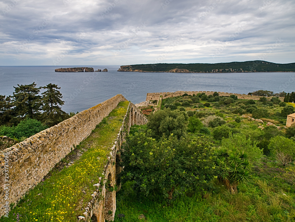 View from  castle walls to sea and islands under dramatic cloudy sky.