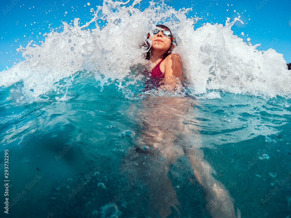 Girl getting splashed by the wave