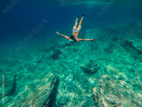 Woman diving into the shallow sea water