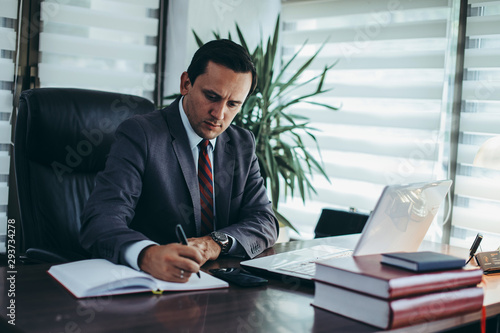 Businessman working at the office. Businessman captures notes.