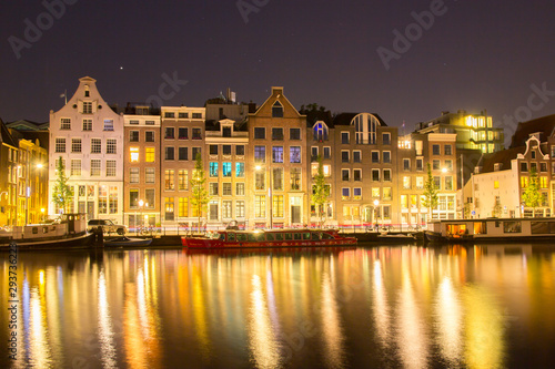 building architecture along canal against reflection of light night 