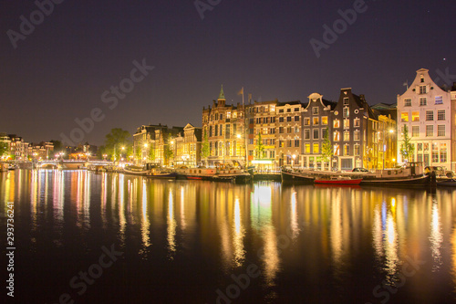 building architecture along canal against reflection of light night  © pong