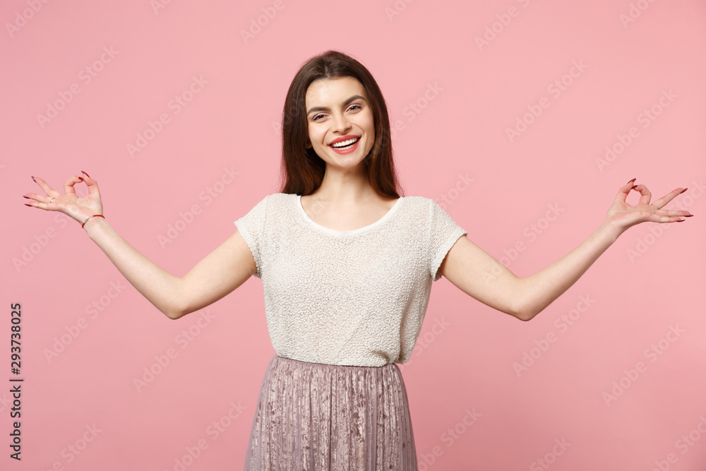 Smiling young woman in casual light clothes posing isolated on pastel pink background, studio portrait. People lifestyle concept. Mock up copy space. Hold hands in yoga gesture, relaxing meditating. Smiling young woman in casual light clothes posing isolated on pastel pink background, studio portrait. People lifestyle concept. Mock up copy space. Hold hands in yoga gesture, relaxing meditating.