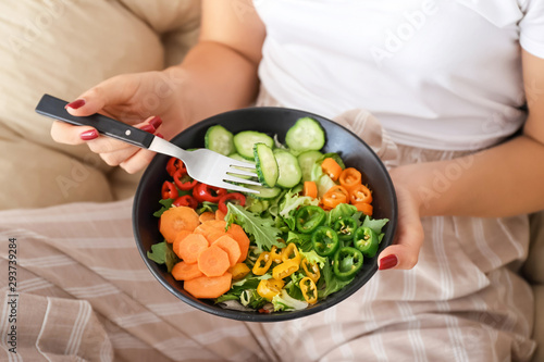 Woman eating tasty vegetable salad, closeup © Pixel-Shot