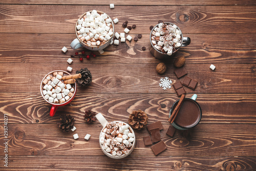 Cups of hot chocolate with marshmallows on wooden table