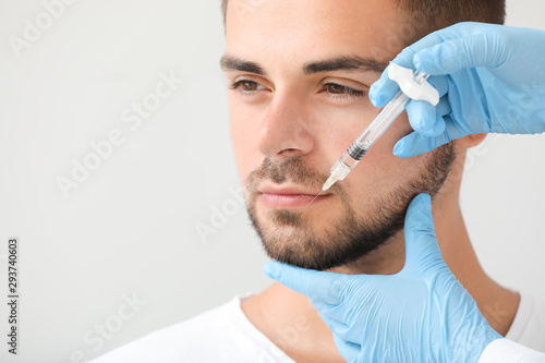 Handsome man receiving fill...