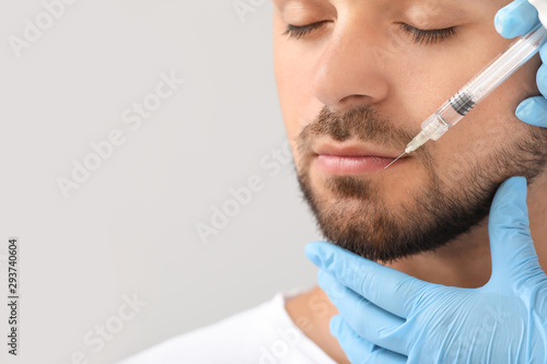 Handsome man receiving fill...