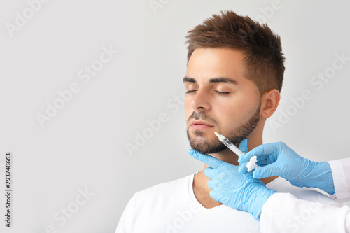 Handsome man receiving fill...