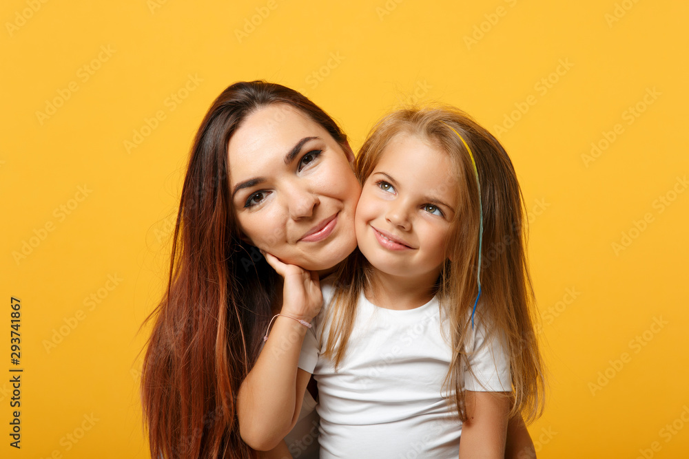 Woman in light clothes have fun with cute child baby girl 4-5 years old. Mommy little kid daughter isolated on yellow background studio portrait. Mother's Day love family parenthood childhood concept. Woman in light clothes have fun with cute child baby girl 4-5 years old. Mommy little kid daughter isolated on yellow background studio portrait. Mother's Day love family parenthood childhood concept.
