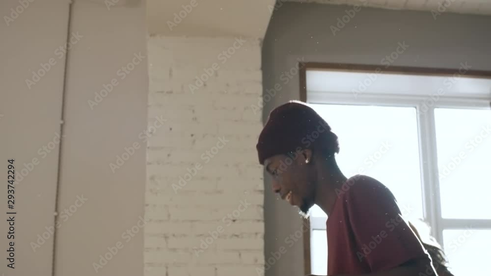 Handheld tracking of black men and woman rehearsing dance moves in studio on sunny day Handheld tracking of black men and woman rehearsing dance moves in studio on sunny day