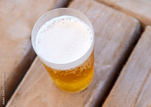 Glass with beer on a wooden background