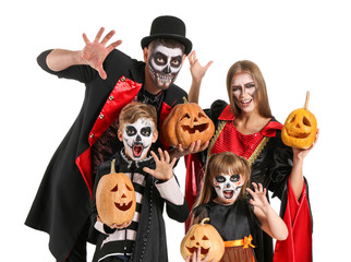 Family in Halloween costumes and with pumpkins on white background