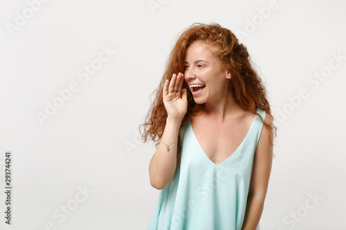Young laughing redhead woman girl in casual light clothes posing isolated on white background, studio portrait. People lifestyle concept. Mock up copy space. Screaming with hand gesture near mouth.