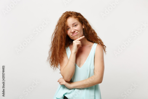 Young confused puzzled redhead woman girl in casual light clothes posing isolated on white wall background, studio portrait. People lifestyle concept. Mock up copy space. Put hand prop up on chin.