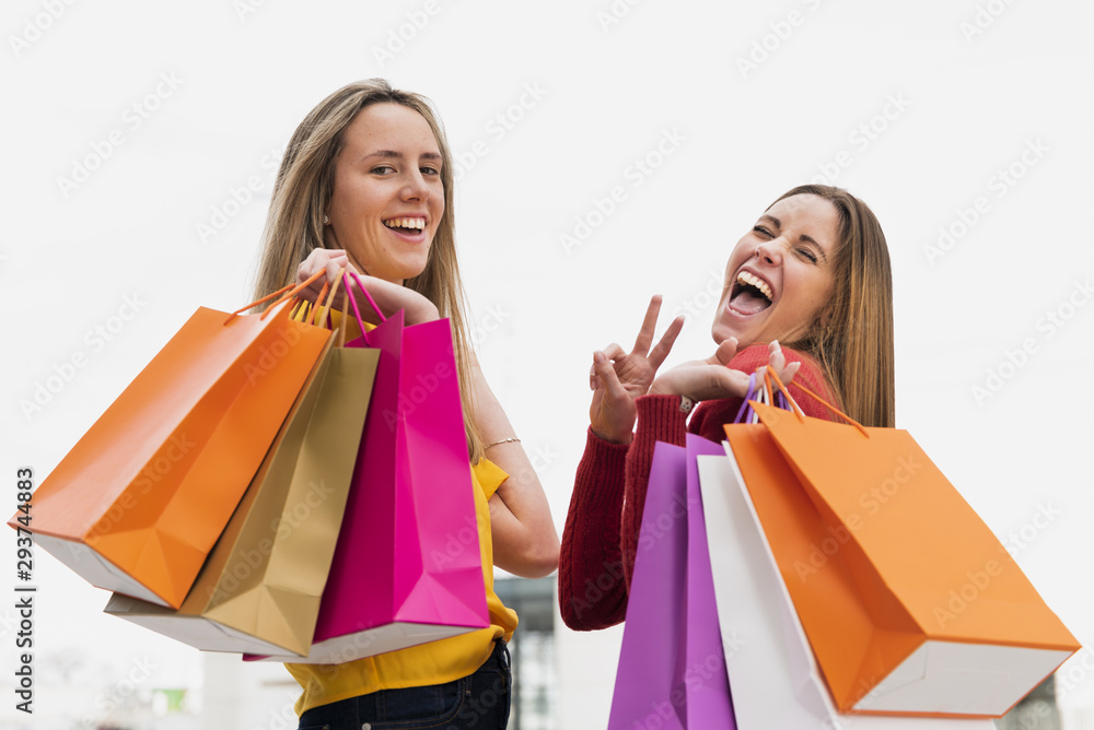 Girls with shopping bags looking at camera