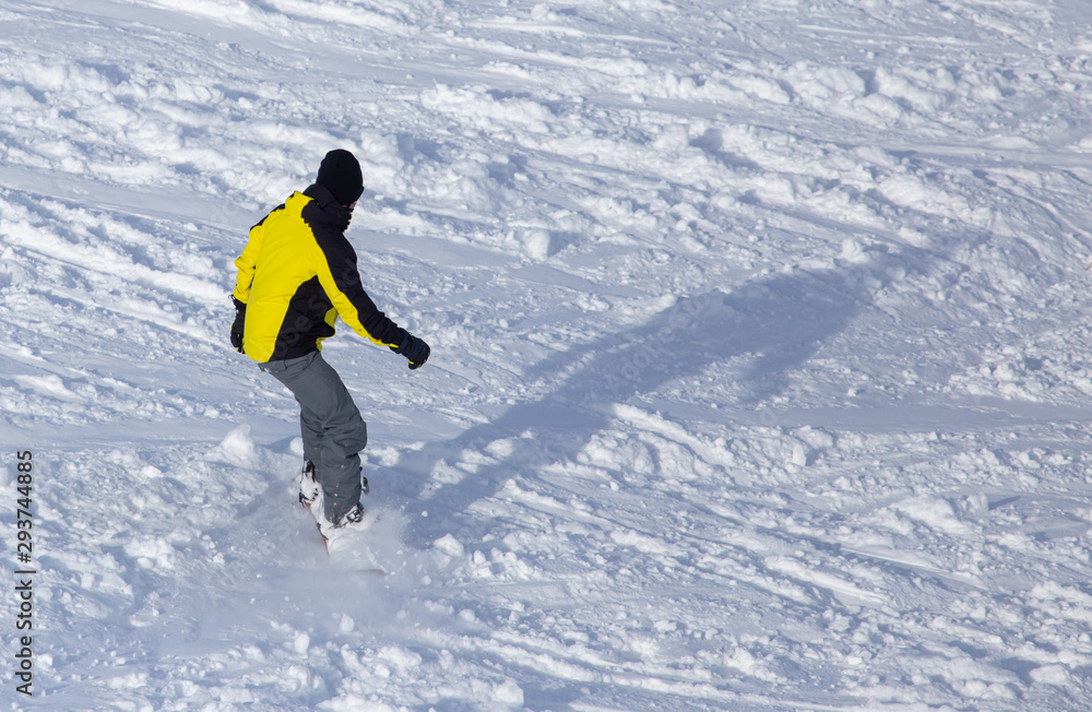 A man snowboarding a mountain in the snow in winter A man snowboarding a mountain in the snow in winter