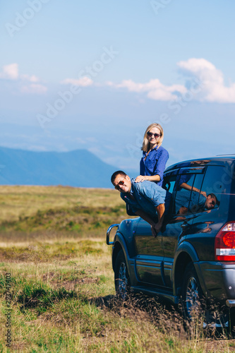 Couple arrived on an SUV high up in the mountain © oksix