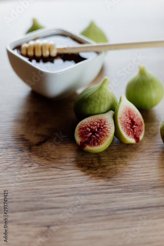 Figs and honey in a white bowl photo