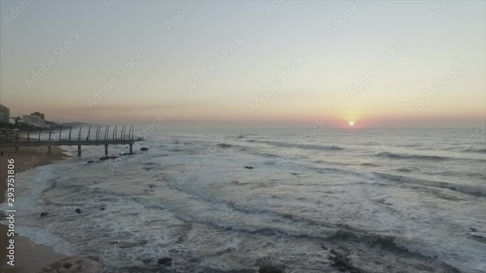 Sunrise View of Ocean and Pier as waves come in Sunrise View of Ocean and Pier as waves come in