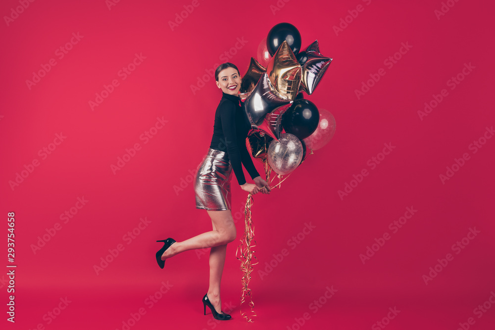 Full length body size view of nice attractive excited positive cheerful cheery girl holding in hands air balls having fun autumn fall isolated on maroon burgundy marsala red pastel color background