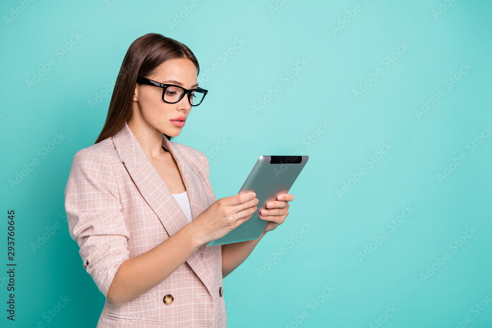 Profile side view portrait of her she nice-looking attractive lovely pretty focused concentrated straight-haired lady reading news isolated over bright vivid shine blue green teal turquoise background