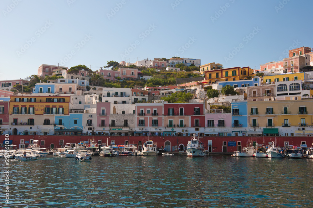 Ponza, Lazio / Italy - August 9 2019: port of the island of Ponza in the summer. The typical colored houses of the island of Ponza. Landscape of the harbor of island of Ponza.