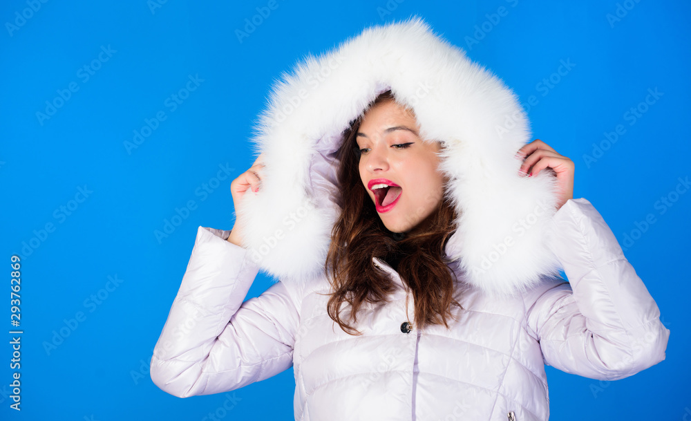 Soft fur. Winter clothes. Girl wear winter jacket blue background. Winter season. Woman wear down jacket with furry hood. Style code with elegance. For those wishing stay modern. Fashion trend Soft fur. Winter clothes. Girl wear winter jacket blue background. Winter season. Woman wear down jacket with furry hood. Style code with elegance. For those wishing stay modern. Fashion trend