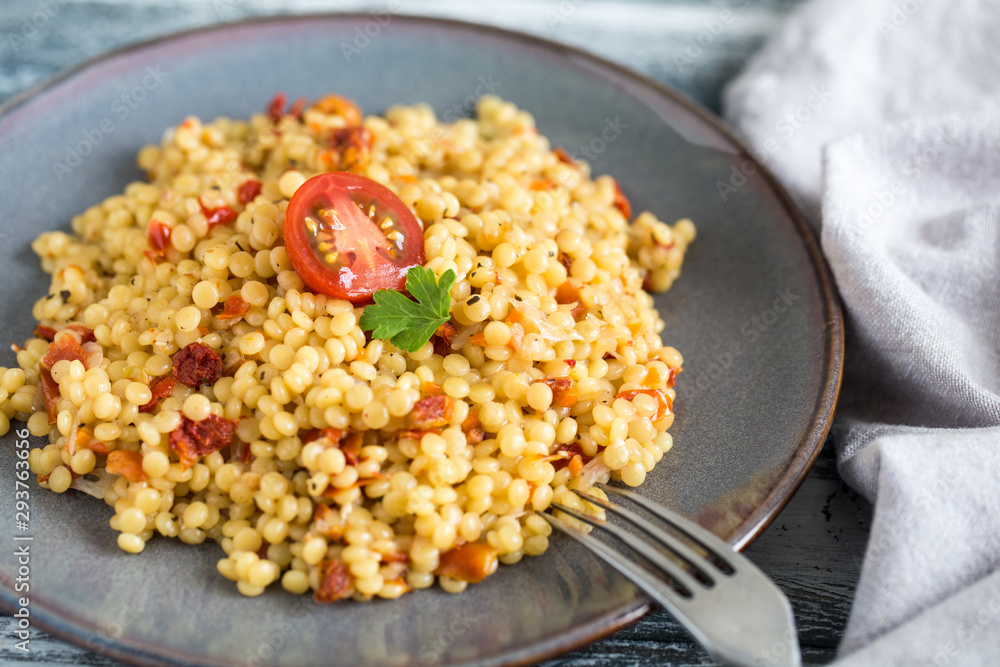 Ptitim or Birdy, Israeli pasta couscous with tomatoes and herbs Ptitim or Birdy, Israeli pasta couscous with tomatoes and herbs