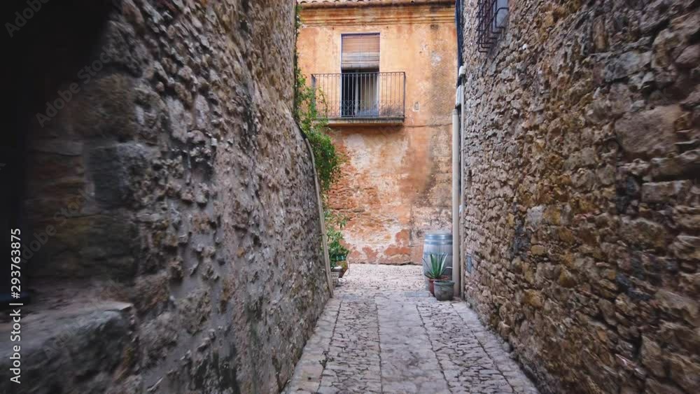 Cobbled street at Peratallada village in Gerona, Catalonia, Spain. Declared a historic-artistic monument. Is known for its beautiful old stone buildings, rutted stone streets and passageways. Cobbled street at Peratallada village in Gerona, Catalonia, Spain. Declared a historic-artistic monument. Is known for its beautiful old stone buildings, rutted stone streets and passageways.