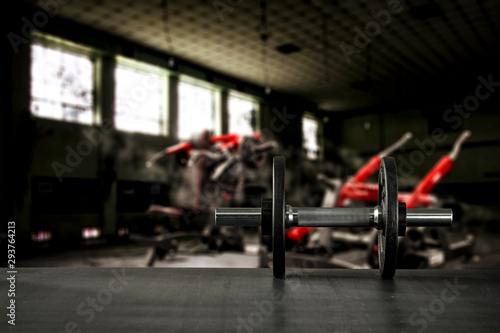 Gym interior and dumbbells on black desk with free space for your decoration. 