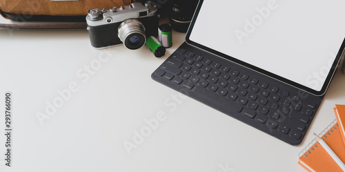 Modern workplace with blank screen tablet with camera and office supplies